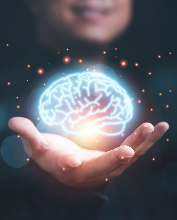 A glowing brain visual hovering above an open hand to represent integrated movement intelligence.